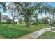 Lush green space in the common area with mature trees, perfect for relaxation and recreation at 3995 Equine Cv, Lake Mary, FL 32746