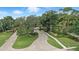 Aerial view of Steeple Chase entrance featuring mature trees, and lush landscaping at 3995 Equine Cv, Lake Mary, FL 32746
