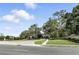 Beautiful entrance to Steeple Chase with lush landscaping, mature trees and stone signage at 3995 Equine Cv, Lake Mary, FL 32746