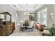 Elegant dining room with chandelier, large windows, and decorative accents, perfect for entertaining at 3995 Equine Cv, Lake Mary, FL 32746