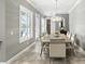 Dining room with ample seating featuring a decorative chandelier and natural light through shuttered windows at 3995 Equine Cv, Lake Mary, FL 32746