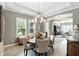 Formal dining room with chandelier lighting, and a seamless view of living spaces for entertaining at 3995 Equine Cv, Lake Mary, FL 32746