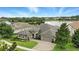 Lovely home overlooking a serene lake, complemented by lush landscaping, and a beautifully paved driveway at 3995 Equine Cv, Lake Mary, FL 32746