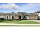 Attractive single-story home with a tile roof, lush green lawn, and a well-maintained landscape under a bright sky at 3995 Equine Cv, Lake Mary, FL 32746