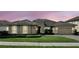 Charming home featuring a tile roof, manicured lawn, and inviting curb appeal, set against a beautiful sunset sky at 3995 Equine Cv, Lake Mary, FL 32746