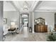 Elegant foyer with tile floors, a chandelier, and stylish decor creating a welcoming and sophisticated entrance at 3995 Equine Cv, Lake Mary, FL 32746