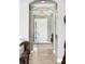Inviting foyer with tile flooring, a chandelier, and an arched entryway offering a glimpse into the home at 3995 Equine Cv, Lake Mary, FL 32746