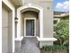 Charming entrance features a gray front door framed by white trim and complemented by tasteful landscaping at 3995 Equine Cv, Lake Mary, FL 32746
