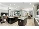 Gourmet kitchen featuring granite countertops, dark cabinetry, stainless steel appliances, with an outdoor dining area view at 3995 Equine Cv, Lake Mary, FL 32746