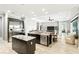 Gourmet kitchen boasts stainless appliances, dark cabinets, and an island with granite countertop at 3995 Equine Cv, Lake Mary, FL 32746