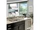 Gourmet kitchen featuring granite countertops, dark cabinetry, stainless steel appliances, with an outdoor grill area view at 3995 Equine Cv, Lake Mary, FL 32746