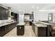 A chef's kitchen featuring stainless steel appliances, dark cabinetry, and granite countertops at 3995 Equine Cv, Lake Mary, FL 32746