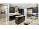 Gourmet kitchen boasts stainless appliances, dark cabinets, and an island with granite countertop at 3995 Equine Cv, Lake Mary, FL 32746