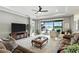 Inviting living room offering seamless indoor-outdoor flow with pool views from large sliding glass doors at 3995 Equine Cv, Lake Mary, FL 32746