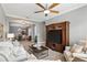 Bright living room with modern ceiling fan, large TV, and stylish furniture leading to the dining area at 3995 Equine Cv, Lake Mary, FL 32746