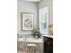 Close up of a soaking tub, floral arrangement, and shuttered window in the main bathroom at 3995 Equine Cv, Lake Mary, FL 32746