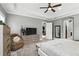 Relaxing main bedroom featuring a plush armchair, neutral colors, and access to an ensuite at 3995 Equine Cv, Lake Mary, FL 32746