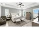 Tranquil main bedroom boasts tray ceilings, neutral tones, and ample natural light from large windows at 3995 Equine Cv, Lake Mary, FL 32746