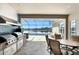 Outdoor kitchen featuring stainless steel grills, mosaic tile backsplash, seating area with a view of the pool and lake at 3995 Equine Cv, Lake Mary, FL 32746