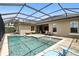 Back exterior view of covered pool, brick pavers, and comfortable seating for relaxing and enjoying the view at 3995 Equine Cv, Lake Mary, FL 32746
