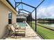 Comfortable outdoor seating with brick pavers, overlooking screened in pool, and tranquil water view at 3995 Equine Cv, Lake Mary, FL 32746