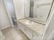 Bathroom featuring a granite-look countertop, white cabinetry, and a large mirror, offering a clean and modern space at 412 Ranch Trl, Casselberry, FL 32707