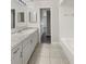 Bathroom with granite-look countertops, white cabinets, and a shower-tub combination, providing a functional space at 412 Ranch Trl, Casselberry, FL 32707