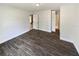 Spacious bedroom with wood-look floors, neutral paint, and easy access to the bathroom and other living areas at 412 Ranch Trl, Casselberry, FL 32707