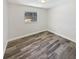 Bright bedroom featuring wood-look flooring and a view of the screened pool at 412 Ranch Trl, Casselberry, FL 32707