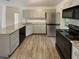 Updated kitchen featuring stainless steel appliances, granite countertops, and gray cabinets at 412 Ranch Trl, Casselberry, FL 32707
