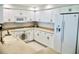 Bright kitchen with all-white cabinetry, countertops, and appliances at 4628 Harbour Village Blvd # 2308, Ponce Inlet, FL 32127