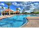 Large community pool with inviting blue water, surrounded by palm trees and lounge chairs at 4628 Harbour Village Blvd # 2308, Ponce Inlet, FL 32127