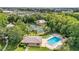 Aerial view of community amenities including a pool, tennis court, racquetball court, clubhouse, and lush green surroundings at 4870 S Semoran Blvd # 1904, Orlando, FL 32822