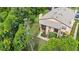 Aerial view of a two-story home surrounded by lush greenery, showcasing its serene setting at 4870 S Semoran Blvd # 1904, Orlando, FL 32822