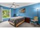 Bedroom with a ceiling fan and view of greenery outside the window, plus simple furnishings at 4870 S Semoran Blvd # 1904, Orlando, FL 32822