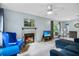 The Living Room features a fireplace, furniture, a ceiling fan, light blue walls, and a window at 4870 S Semoran Blvd # 1904, Orlando, FL 32822