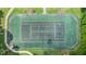 Aerial shot of a fenced-in tennis court showing the court's surface, surrounding trees and pathway around it at 4870 S Semoran Blvd # 1904, Orlando, FL 32822