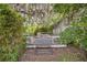 Secluded backyard deck surrounded by lush landscaping and a large tree providing shade at 516 Tybee Pl, Orlando, FL 32829