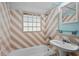 A colorful bathroom with unique patterned tile, a pedestal sink, and a shower/tub combo at 516 Tybee Pl, Orlando, FL 32829