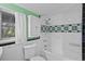Classic bathroom with white tiled walls, black accent tiles, and built-in shelving at 516 Tybee Pl, Orlando, FL 32829
