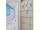 Bathroom with colorful accent tile, light blue walls, and glass display shelving at 516 Tybee Pl, Orlando, FL 32829