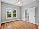 Bright bedroom features hardwood floors, a ceiling fan, and an adjacent bathroom at 516 Tybee Pl, Orlando, FL 32829