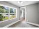 Well-lit room with two large windows and views of the front yard, complemented by neutral carpet and paint at 516 Tybee Pl, Orlando, FL 32829