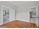 This bedroom has hardwood floors with doorways to a bathroom and kitchen at 516 Tybee Pl, Orlando, FL 32829