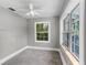 Cozy bedroom featuring two bright windows, neutral carpet and walls, and a ceiling fan at 516 Tybee Pl, Orlando, FL 32829