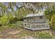 Quaint home exterior featuring a spacious wooden deck and lush foliage, offering a peaceful retreat at 516 Tybee Pl, Orlando, FL 32829