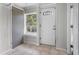 Bright entryway featuring a white door with decorative glass, neutral tile flooring, and fresh white walls at 516 Tybee Pl, Orlando, FL 32829