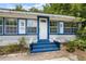Inviting front entrance featuring blue-painted steps and trim, bright white siding, and a classic white door at 516 Tybee Pl, Orlando, FL 32829