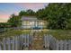Charming single-story home with blue trim, a quaint picket fence, and lush surrounding trees at 516 Tybee Pl, Orlando, FL 32829
