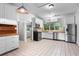 Spacious kitchen with stainless steel appliances, white cabinetry, and tiled flooring at 516 Tybee Pl, Orlando, FL 32829